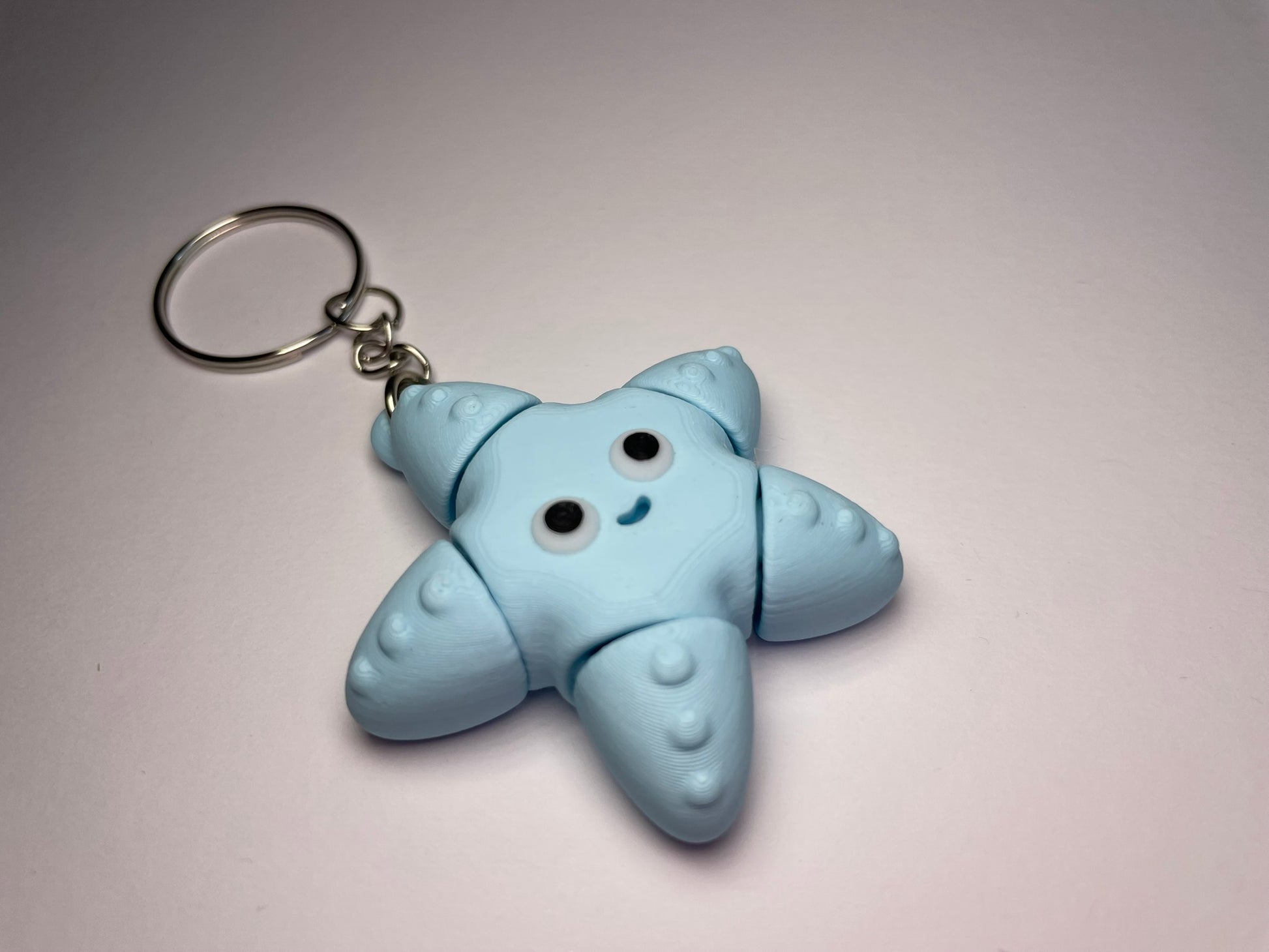 Flexi-Seestern Schlüsselanhänger mit beweglichem Design, blau